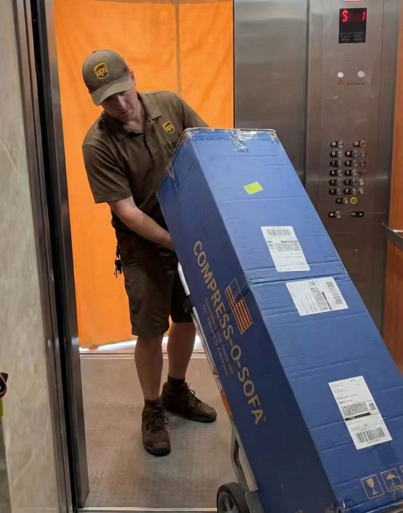 The compressed sofa is making its way into the elevator.